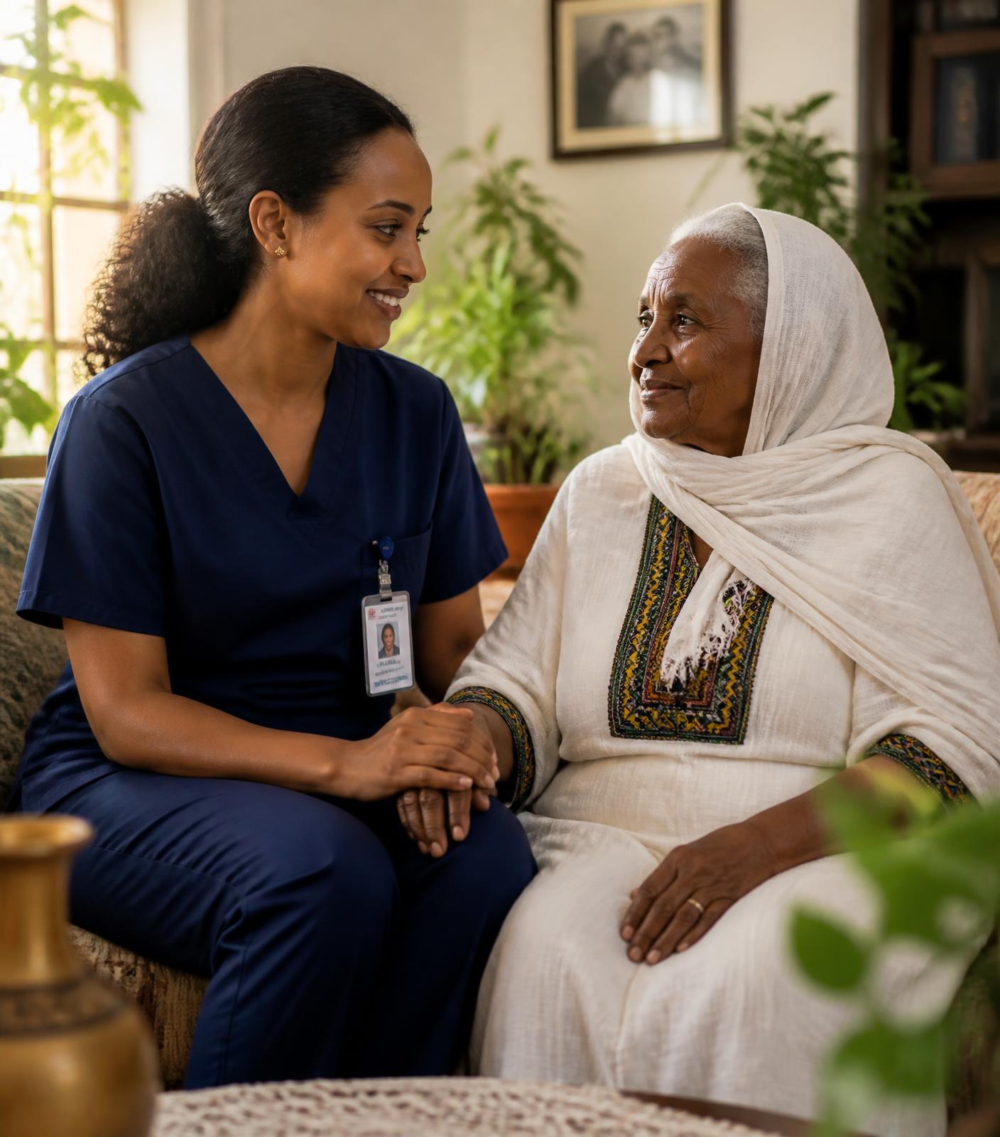 A nurse sitting with an elderly Ethiopian woman in her home in Addis Ababa